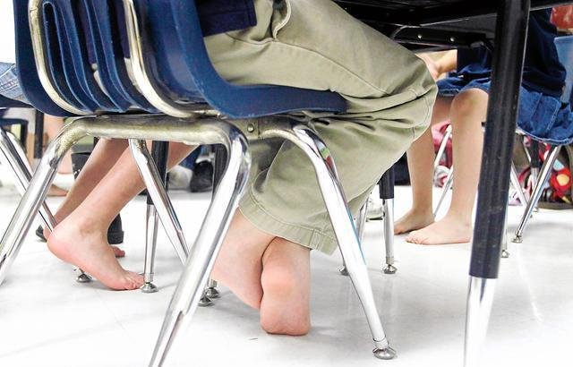 Bare feet under chairs