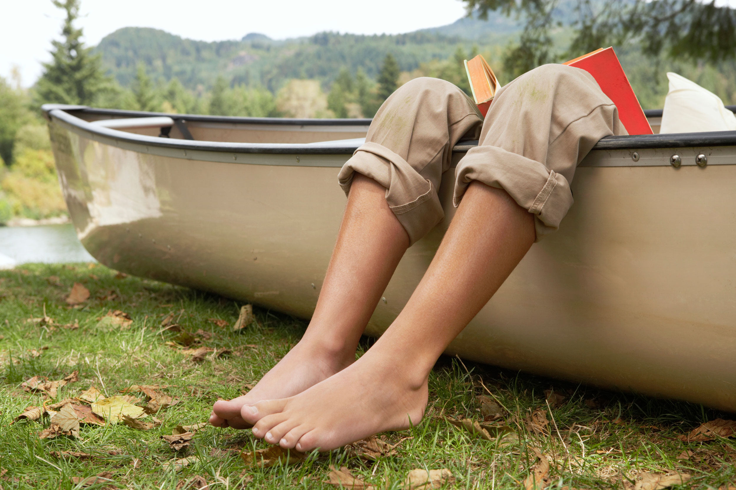Legs and bare feet outside a boat
